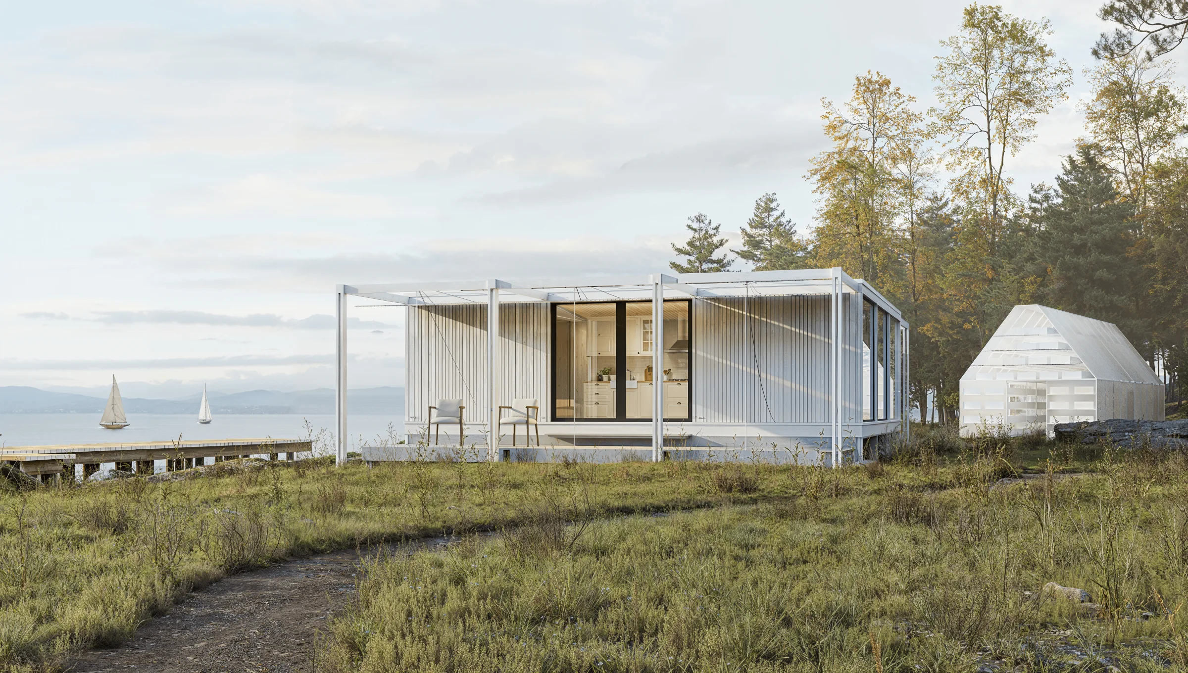 STUDIO RAUM on a grassy coastal site, with a pergola frame and the sea behind.
